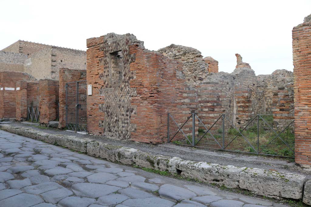 VI.3.4, Pompeii, on right. December 2018. 
Looking north-east to entrances on Via Consolare, from VI.3.1, VI.3.2, VI.3.3 and VI.3.4. Photo courtesy of Aude Durand.
