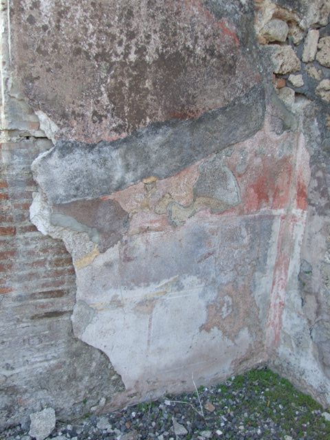 VI.7.6 Pompeii. March 2009. Room 10, east end of north wall of triclinium, with remains of painted plaster.