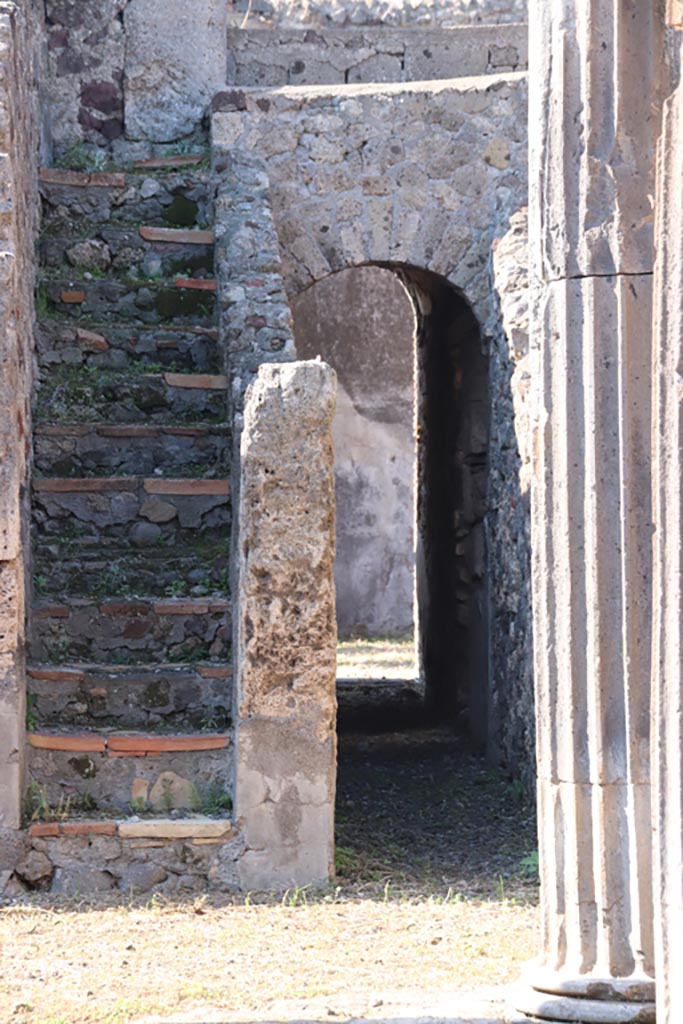 VI.7.21 Pompeii. October 2022. 
Staircase to upper floor, and corridor through arch to rear and linking with peristyle of VI.7.20.
Photo courtesy of Klaus Heese. 
