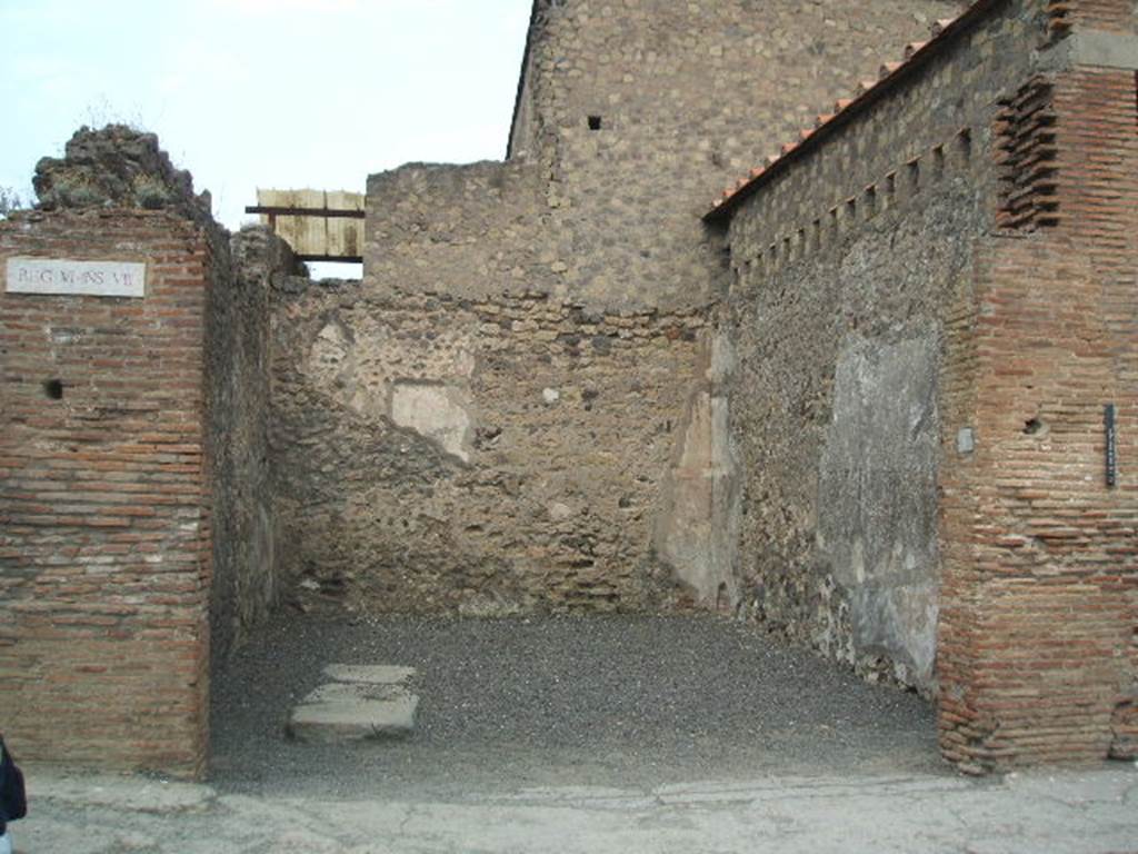 VI.8.4 Pompeii. May 2005. Looking north to shop entrance doorway.
According to Pagano and Prisciandaro, various graffiti were found written on the south-west corner of insula 8.  They may have been written on the pilaster (on the left) or may have been around the corner, on the side wall. 
Written in red  C(aium) Iulium Polybium IIvir(um)    [CIL IV 147 = CIL IV 258]
M(arcum) Cerrinium    [CIL IV 256]
Suettium    [CIL IV 257]
Nero L() <Po=OP>pae(a)e ses factum    [CIL IV 259]
M(arcum) Mallium aed(ilem)    [CIL IV 260]
See Pagano, M. and Prisciandaro, R., 2006. Studio sulle provenienze degli oggetti rinvenuti negli scavi borbonici del regno di Napoli. Naples : Nicola Longobardi.  (p.129) 
