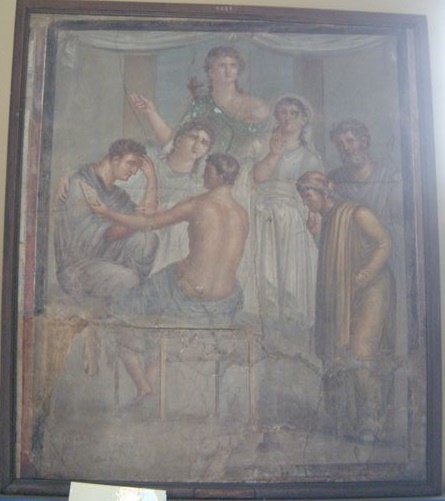 VI.8.5 Pompeii. Tablinum east wall. PPM shows this picture of Alcestis and Admetus. 
According to PPM, Alcestis and Admetus appear seated while the oracle refers to the imminent death of Admetus; the parents of the young bride and a girl attend the scene, on the right the bust of Apollo.
Now in Naples Archaeological Museum. Inventory number 9025.
See Carratelli, G. P., 1990-2003. Pompei: Pitture e Mosaici: Vol. IV. Roma: Istituto della enciclopedia italiana, p. 546-7, n. 36.
According to Bragantini, in PPM, p. 547, the picture inv. 9025 is wrongly attributed to the House of the Tragic Poet and also by Schefold to the Masseria di Irace and she is not aware of its origin.
See Bragantini I., 2001. Quadri con la rappresentazione della storia di Admeto e Alcesti: MEFR. Antiquité, tome 113, n°2. 2001. Antiquité. p. 813 e nota 45.
