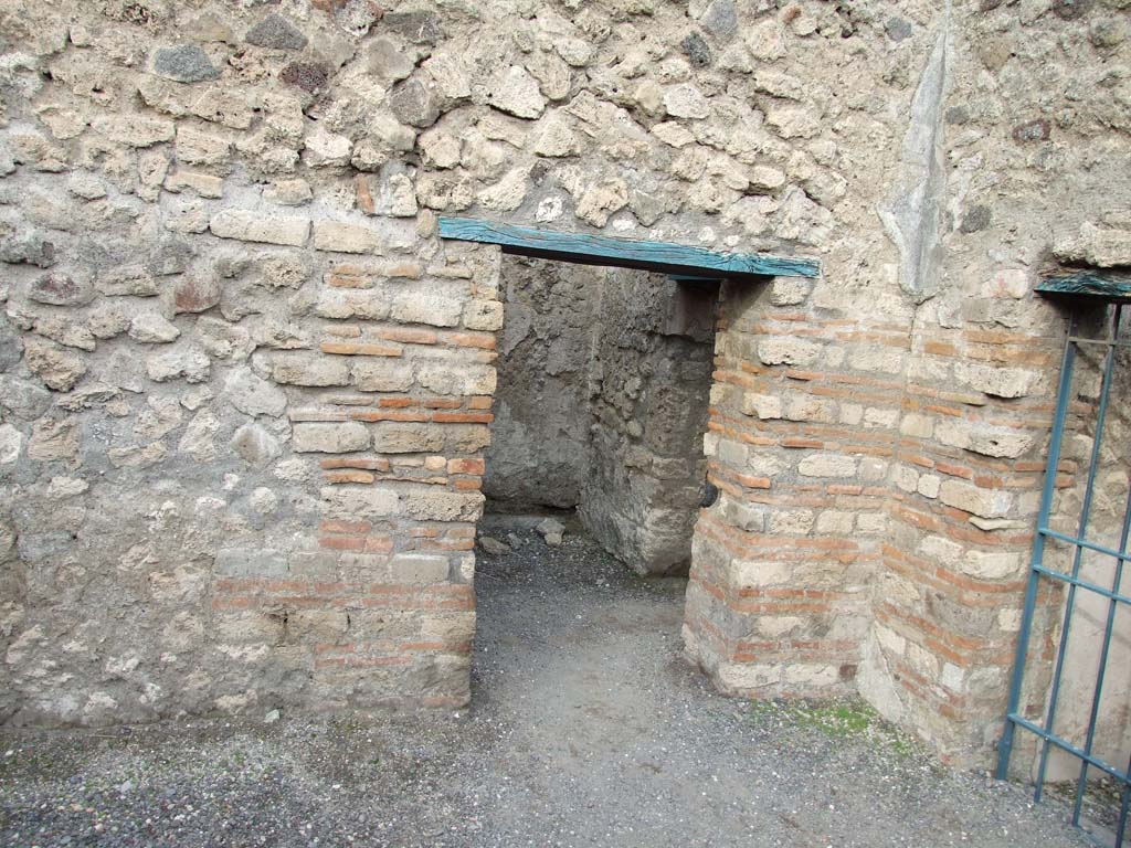 VI.8.9 Pompeii. December 2007. 
North-east corner of large rear room, with open doorway to small room at rear. The barred gate is the doorway to VI.8.13.
