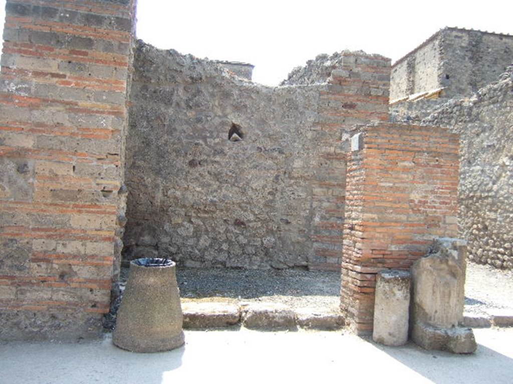 VI.8.12 Pompeii. May 2006. Looking west to entrance doorway.
According to Della Corte, on the left of entrance number 12 was found an electoral recommendation from the Pomari (the fruitsellers)
Pomari rog(ant) [CIL IV 180].
Between the entrances of VI.8.12 and 13 was found 
Pomari facite     [CIL IV 183], and then opposite this third, was found 
Pomari rog(ant)    [CIL IV 149]
A fourth recommendation could be read on the exterior of the House of Helvio Vestale (VI.8.22/1)
Pomari rog(ant)    [CIL IV 206]      and also near this last was found 
Pomari universi
Cum Helvio Vestale rog(ant)    [CIL IV 202]
Della Cortes theory was that this all proved that Helvius Vestalis was the protector, the head of the collegium of fruitsellers of Pompeii, and that the meetings of the society were perhaps held in the upper rooms of number 12 and 13.  See Della Corte, M., 1965.  Case ed Abitanti di Pompei. Napoli: Fausto Fiorentino. (p.59)
According to Epigraphik-Datenbank Clauss/Slaby (See www.manfredclauss.de), these read as 
M(arcum) Enium Sabinum 
aed(ilem) pomari rog(ant)      [CIL IV 180]
Vettium Firmum
aed(ilem) o(ro) v(os) f(aciatis) dign(um)
est pomari facite                      [CIL IV 183]
M(arcum) Cerrinium
aed(ilem) pomari rog(ant)      [CIL IV 149]
M(arcum) Holconium
Priscum aed(ilem) pomari rog(ant)      [CIL IV 206]
M(arcum) Holconium
Priscum IIvir(um) i(ure) d(icundo)
pomari universi
cum Helvio Vestale rog(ant)     [CIL IV 202]
According to Pagano and Prisciandaro, found in July 1825 written on the wall on the left, was 
Marcellum aediles
et Albucium
o(ro) v(os) f(aciatis)    [CIL IV 182]
and in September 1825, found written in red, were 
Faustinium    [CIL IV 185]
L(ucium) Albucium    [CIL IV 186]
and in February 1826, found painted in red, on the pilaster between 12 and 13, was 
M(arcum) Albucium aed(ilem)    [CIL IV 184]
See Pagano, M. and Prisciandaro, R., 2006. Studio sulle provenienze degli oggetti rinvenuti negli scavi borbonici del regno di Napoli.  Naples : Nicola Longobardi. (p. 133-4)   PAH II, 135,  PAH II, 148.
