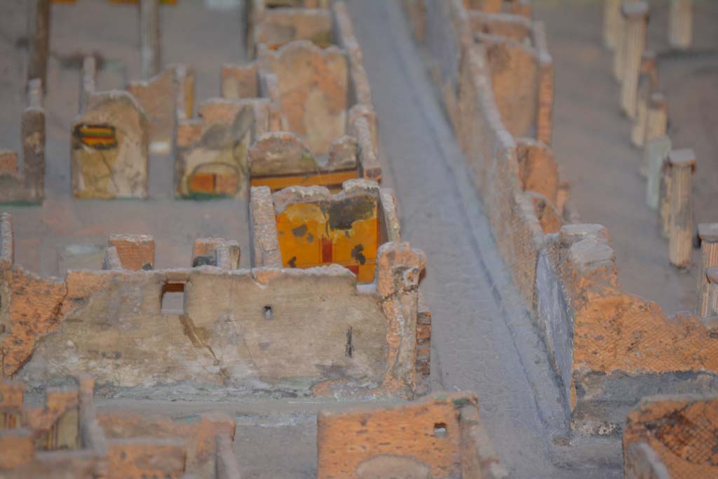 VI.11.9/10 Pompeii. July 2017. Looking east from junction of (lower) Vicolo del Fauno and Vicolo del Mercurio, centre right.
The yellow wall (next to Vicolo di Mercurio) is the east wall of room 5.
From cork model in Naples Archaeological Museum.
Foto Annette Haug, ERC Grant 681269 DCOR.

