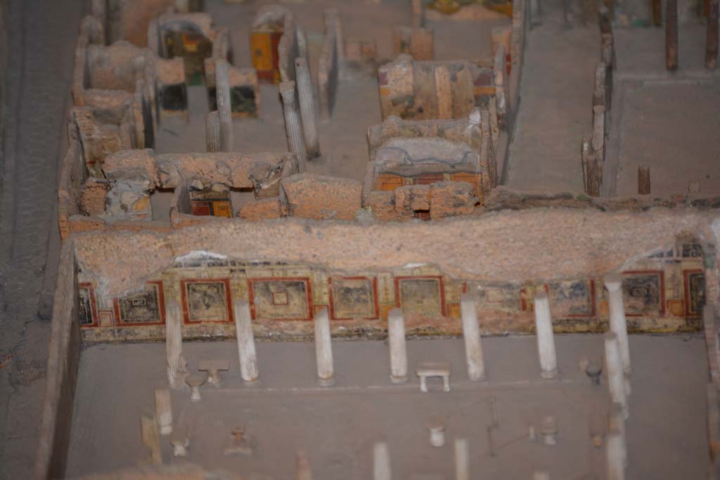 VI.11.9/10 Pompeii. July 2017. Looking west.
Across the centre, on the east side of atrium 27, the west wall of rooms 26, and the red/black west wall of room 30 can be seen.
From cork model in Naples Archaeological Museum.
The lower west wall and peristyle belong to VI.15.1, thr House of Vettii.
Foto Annette Haug, ERC Grant 681269 DCOR.

