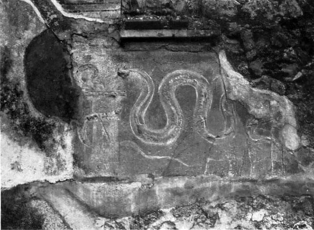 VI.14.34 Pompeii. 1930s photo by Tatiana Warscher of lararium on west wall.
According to Boyce, on the west wall facing the oven, above a low table, was a red panel in which two serpents were represented in stucco relief.
One of them was coiled about an altar; the second approached the same altar from the right.
The second serpent was the larger of the two and had crest and beard.
Across the top of the panel ran a stucco cornice.
See Notizie degli Scavi di Antichità, 1876, p. 195; Bull. Inst., 1878, 196.
See Boyce G. K., 1937. Corpus of the Lararia of Pompeii. Rome: MAAR 14. (p.53, no.204, with Pl. 28,4). 
