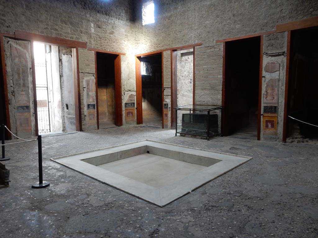 VI.15.1 Pompeii. January 2023. 
Looking south across atrium with strongbox/money box/safe, in centre. 
The statue of Priapus in the south ala, on the right, has been moved to the peristyle. Photo courtesy of Miriam Colomer.


