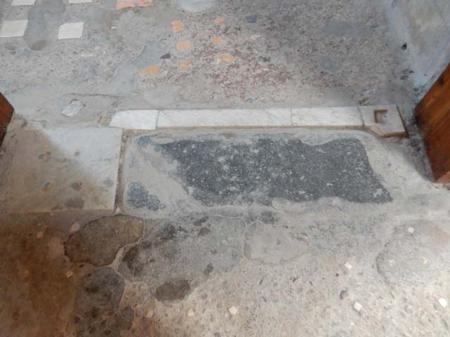 VI.15.1 Pompeii. December 2006. View of North side of Atrium. Masonry base that supported the iron and bronze strongbox or safe. The safe was being restored as at December 2006.