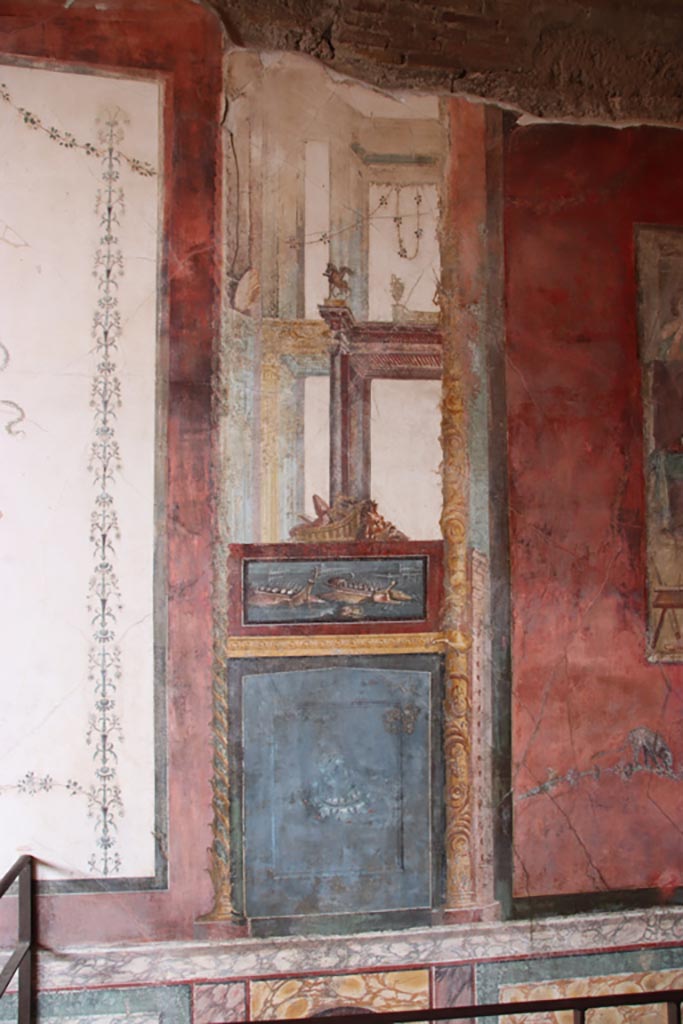 VI.15.1 Pompeii. December 2006. North wall of exedra with wall painting of naval scene, with basket and mask above.
