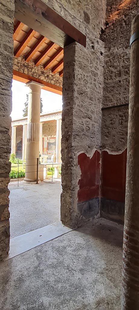 VI.15.1 Pompeii. April 2023. 
South-west corner of courtyard “s”, with doorway to large peristyle “m”.
Photo courtesy of Giuseppe Ciaramella.


