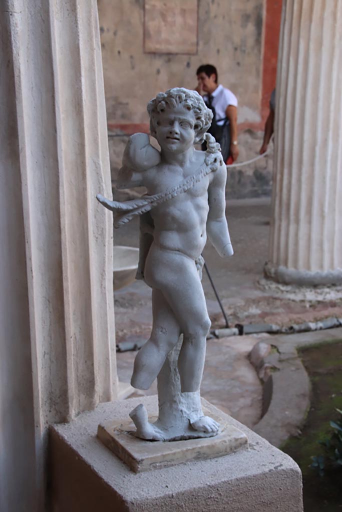 VI.15.1 Pompeii. October 2023. 
Detail of statue of Cupid from south portico. Photo courtesy of Klaus Heese.
