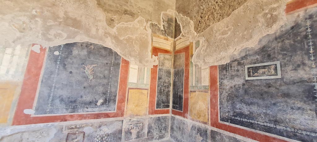 VI.15.1 Pompeii. April 2023. 
Painted wall decoration in south-west corner, with west wall, on right. Photo courtesy of Giuseppe Ciaramella.
