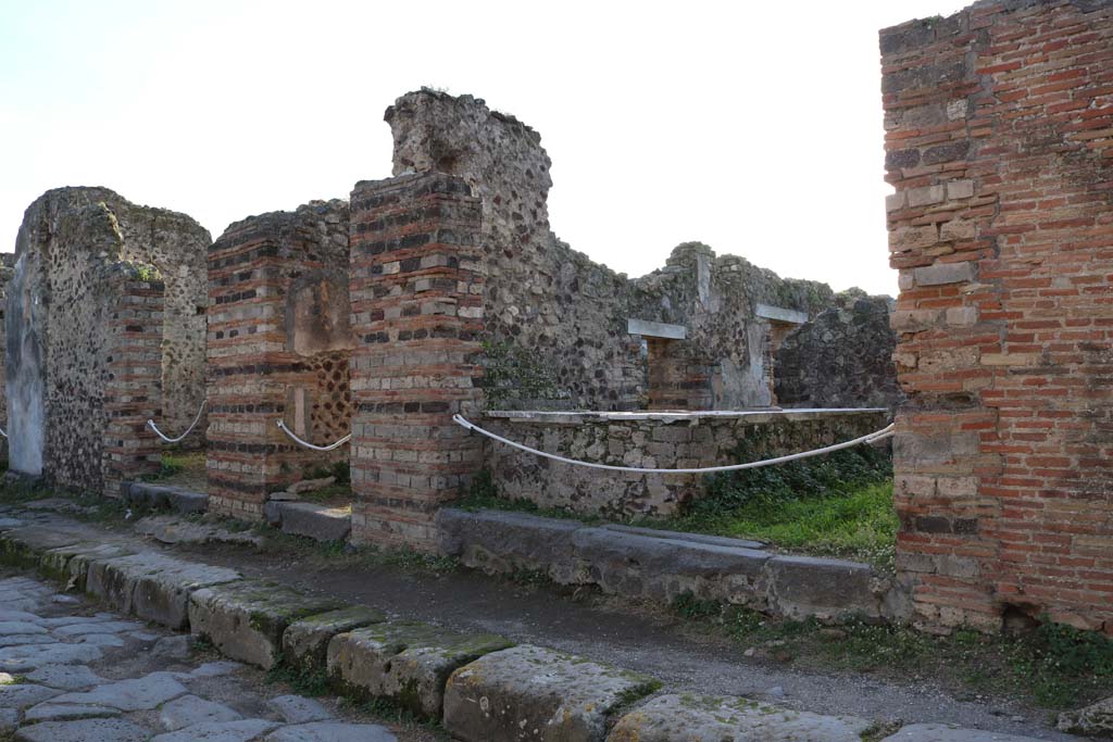 VI.15.15 Pompeii, on right. December 2018. 
Looking south-east towards entrances on west side of Vicolo dei Vettii. Photo courtesy of Aude Durand.


