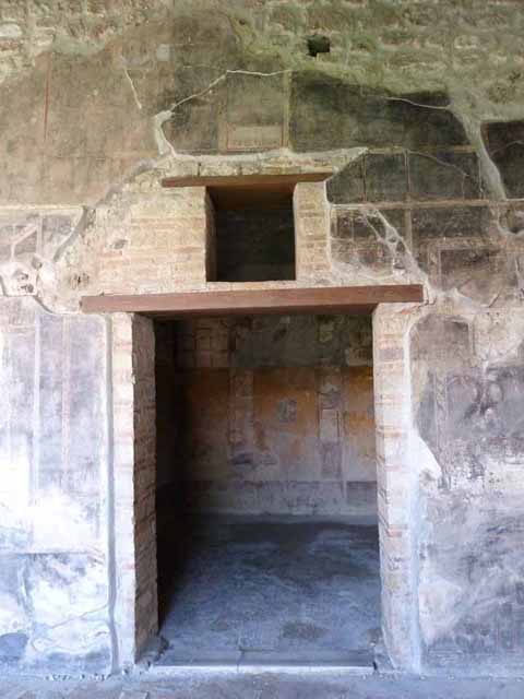 VI.16.7 Pompeii. May 2010. Looking west to doorway to services area from north-west corner of portico. 