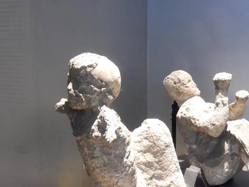 VI.17.42, Pompeii, May 2018. 
Plaster cast of a child, on left, and man, on right, found in the corridor leading to the garden area.
Photo courtesy of Buzz Ferebee.
