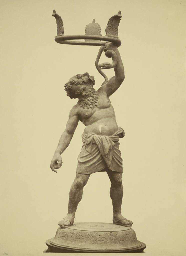VII.2.20 Pompeii. Found 21st May 1864 in peristyle. Old undated photograph.
Bronze statue of Drunken Silenus, intended as a stand for a vase, of which the fragments were found nearby.
Now in Naples Archaeological Museum. Inventory number 5001.
See Real Museo Borbonico, Vol. XVI, tav. XXIX.
