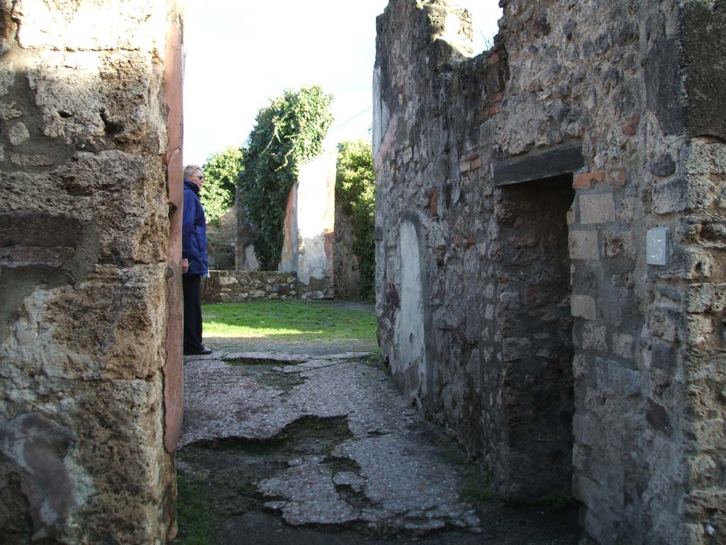 VII.2.23 Pompeii. December 2004. Looking east along entrance corridor, with doorway to latrine, on right.