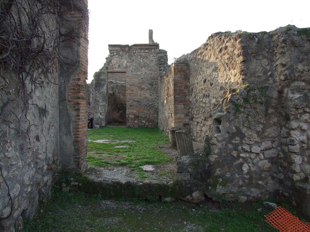 VII.2.23 Pompeii. December 2006. 
Looking west from rear through doorway of triclinium, across atrium, to the doorway to cubiculum on north side of entrance. 
