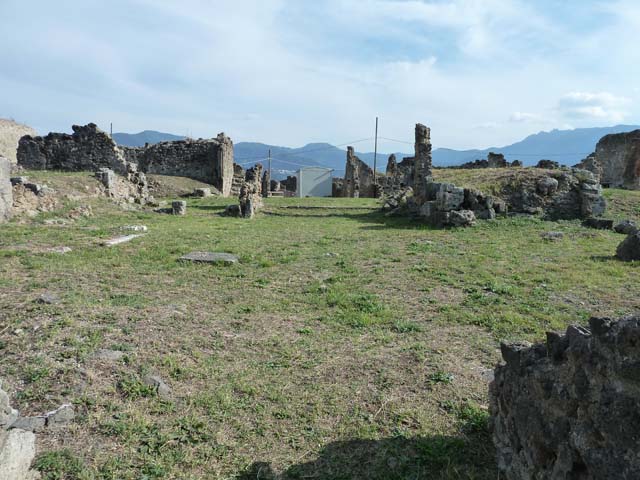 VII.6.7 Pompeii. Undated postcard. Looking north from above atrium of VII.6.7. The entrance doorway would have been the one on the right of the centre of the photo, opposite Via Consolare. This shows the north wall of the atrium, at the rear of VII.6.4, 5 and 6.