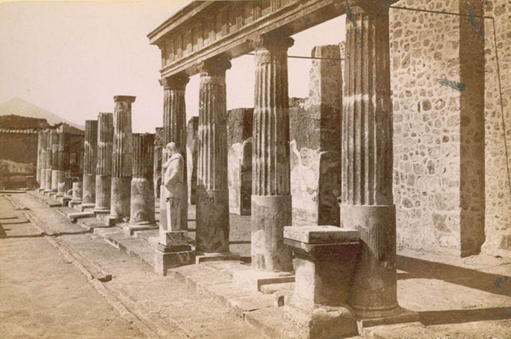 VII.7.32 Pompeii. 1880. East side of Temple of Apollo. Note the statue, a marble herm of Hermes or Mercury, in front of the fifth column. Photo courtesy of Rick Bauer.