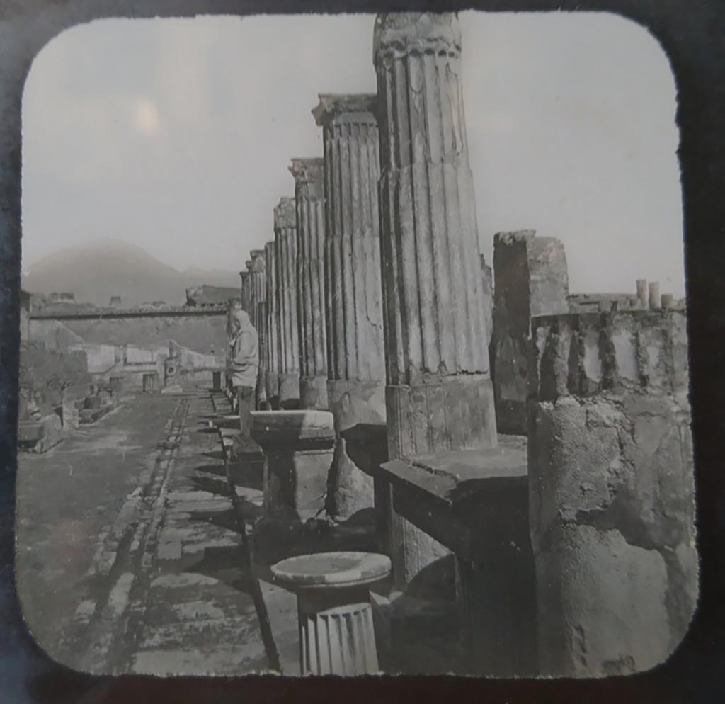 VII.7.32 Pompeii. c.1900. C. and G. Lantern slide published by A. Laverne. 
Looking north along east portico towards north wall, still with painted decoration. The Forum is on the right.   
