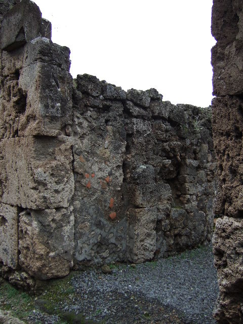 VII.9.63 Pompeii. December 2005. Latrine in kitchen or work area.
According to Hobson, the original latrine was at the end of a narrow corridor to the north of the house. Probably in the first century, this latrine was sealed over and replaced by a latrine in the room immediately to the left of the doorway. This room might then have become a work area and perhaps housed the kitchen as well as the toilet. Next door to VII.9.63 a new entrance from the street was made, giving access via a staircase to the upper storey, and to the right of the stairs another new latrine was constructed. This was now back to back with the one in VII.9.63 and emptied into the same cesspit. In addition the staircase led to an upper storey latrine, the down pipe from which was inserted into the wall. The provision here of three latrines leads one to ask who used each of them?.  
See Hobson, B., 2009. Latrinae et foricae: Toilets in the Roman World. London; Duckworth. (p.68)
