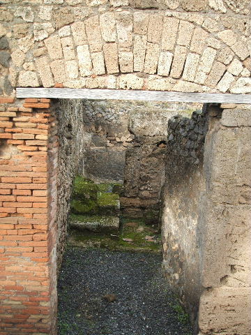 VII.9.64 Pompeii. December 2005. Steps to upper floor in north-west corner, and latrine in north-east.