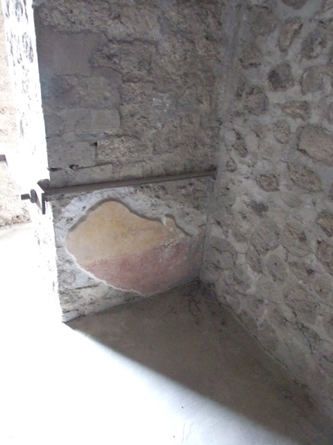 VII.12.20 Pompeii. March 2009. Remains of painted plaster under window sill of Room 4.