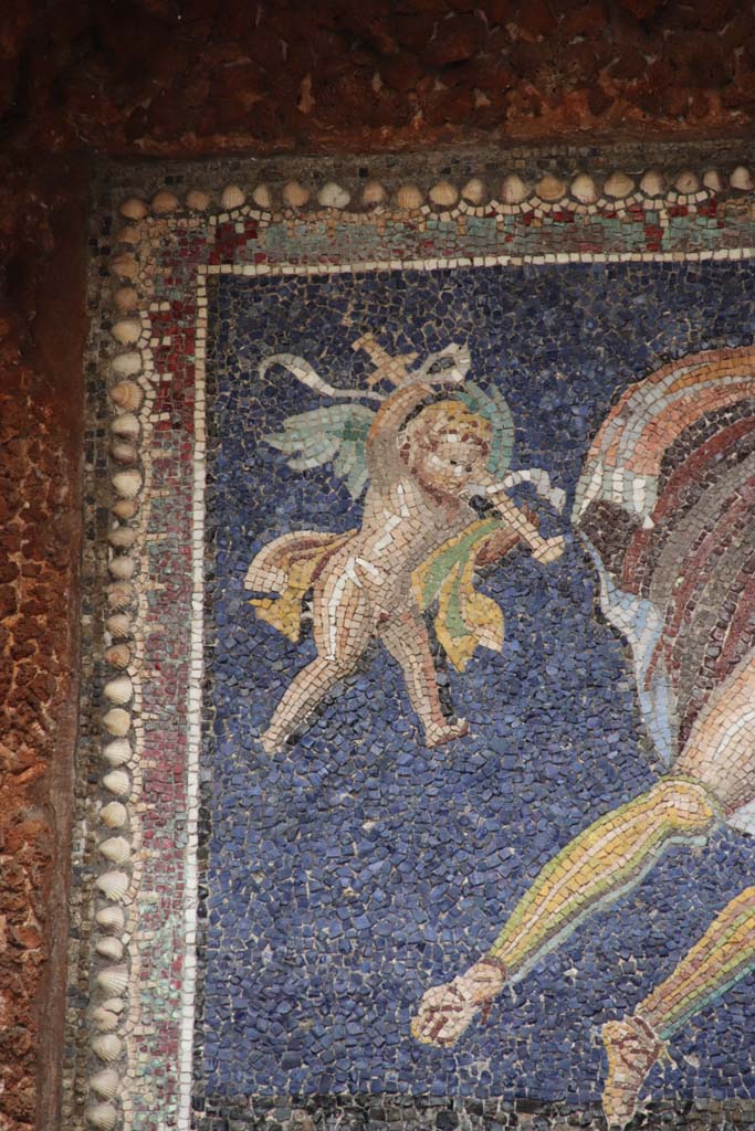 VII.16.a Pompeii. September 2021.  
Room 9, nymphaeum, detail of mosaic cherub. Photo courtesy of Klaus Heese.
