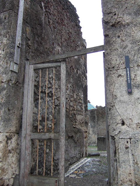 VIII.2.1 Pompeii. December 2005. Two doorways to small rooms or cupboards in south-east corner of atrium.