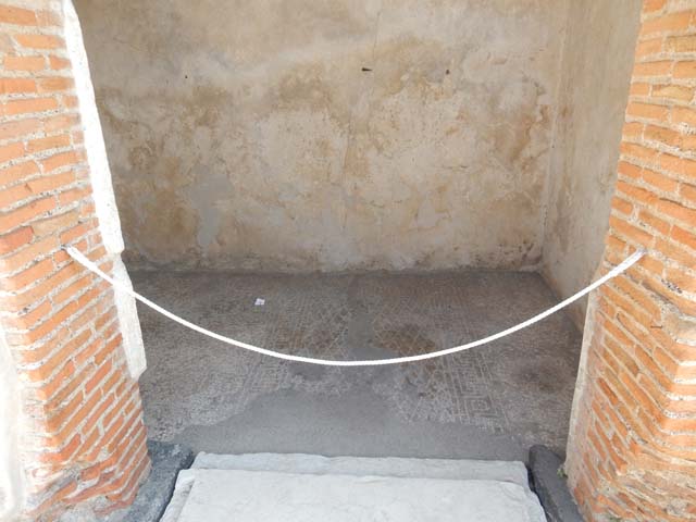 VIII.2.16 Pompeii. September 2005. Remains of aedicula household shrine. According to Boyce, in the third small room on the south of the atrium, against he south wall stand the ruins of an aedicula. A masonry podium that was ornamented along the upper edge with a stucco cornice, supported the shrine. The shrine was built of tufa and coated with white stucco contemporary with the walls of the room. This was spread not long before the catastrophe. The inside of the aedicula was divided into two storeys, each supported by two columns and two antae. The roof was flat and adorned with terracotta antefixes. One of these was preserved and represented a male face in the centre of a kind of palmette. Nearby was found a small tufa altar, Not. Scavi, 1893, 48. See Boyce G. K., 1937. Corpus of the Lararia of Pompeii. Rome: MAAR 14. (p.74, no.343)
.