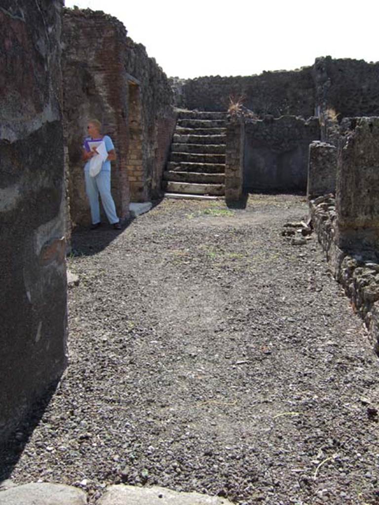 VIII.3.14 Pompeii. September 2005. 
Looking south along east side of atrium towards kitchen doorway and steps in south-east corner.
