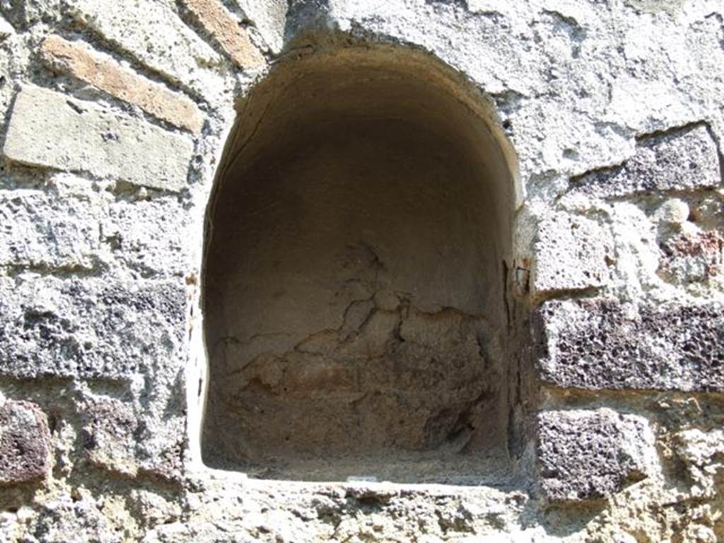 VIII.4.4 Pompeii. March 2009. Room 7, niche on east wall of kitchen.
According to Boyce, this small arched niche was above a masonry tub and adorned with an aedicula faade.
See Boyce G. K., 1937. Corpus of the Lararia of Pompeii. Rome: MAAR 14. (p.76) 
See Giacobello, F., 2008. Larari Pompeiani: Iconografia e culto dei Lari in ambito domestico.  Milano: LED Edizioni. (p.199)
