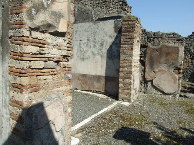 VIII.4.4 Pompeii. March 2009. Room 18, detail of lower section of west side of north wall of oecus. 