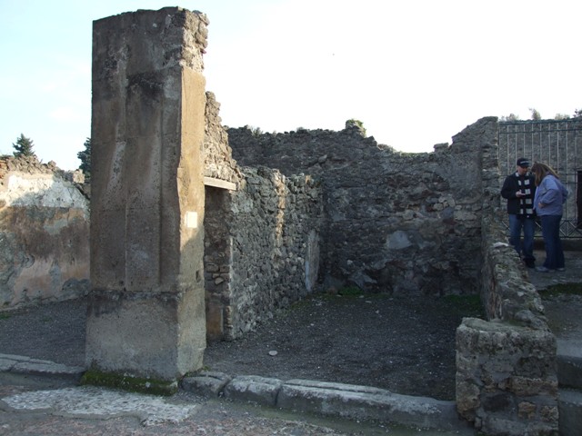 VIII.5.6 Pompeii. May 2005. East wall with communicating doorway to VIII.5.7, and south wall.  According to Hobson, a wall scar of a down-pipe can be seen in the south-east corner of the shop. See Hobson, B., 2009. Pompeii, Latrines and Down Pipes. Oxford, Hadrian Books. (p.460).  
