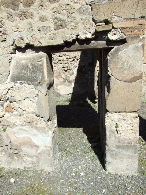 VIII.5.9 Pompeii.  March 2009. Room 23. South wall, with small door in south east corner.