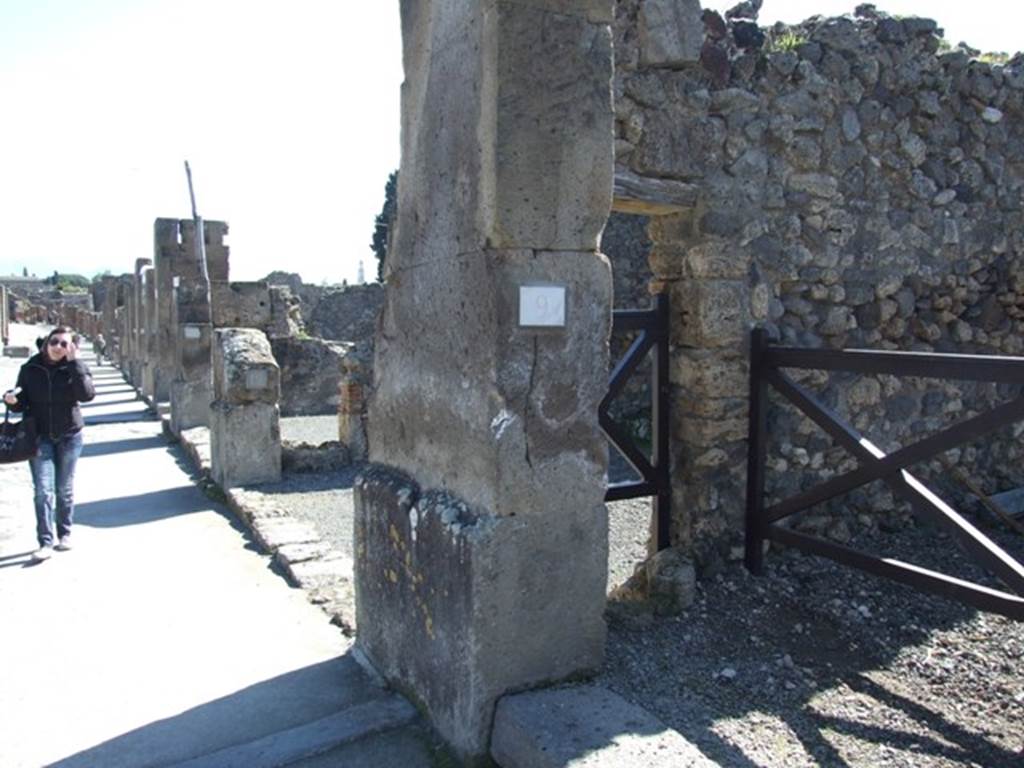 VIII.5.9 Pompeii. March 2009. East side of entrance fauces on Via dellAbbondanza, with puteal for a well in small doorway to shop at VIII.5.10
According to Maiuri, 
This house also opened onto the south side of the Via dellAbbondanza, with a doorway in tufo between two shops; it had a short but wide entrance corridor with undecorated walls in large part restored after the earthquake; a stone threshold was on the external side of the doorway and one of travertine on the interior between the corridor and the atrium; a puteal for a well was embedded in the left wall, where it would have been used above all by the neighbouring shop (another puteal was inserted in the dividing wall between the shops numbered 10 and 11.
see Maiuri in Notizie degli Scavi, 1944-45, (p.154). 
shop at VIII.5.10