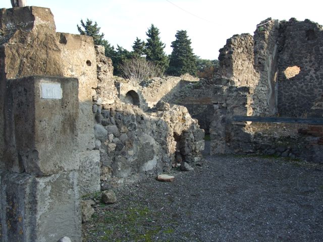 VIII.5.11 Pompeii. December 2007. Step and doorway to atrium of VIII.5.9, in south-west corner of shop.