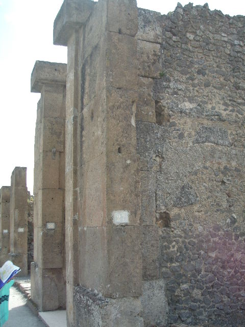 VIII.5.27 Pompeii. May 2005. Looking south at entrance to shop.
On the right at the rear would have been the steps to the upper floor, the base of them can just be seen. The remains of the downpipe from upper floor can also be seen in the wall in the south-west corner (on the right).
