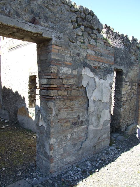 VIII.5.39 Pompeii. March 2009. Room 6, small garden area.  
South wall with window, and west wall. Looking west. According to Jashemski, this small garden area had a raised strip of soil at the base of the walls. In the middle was a pavement, serving as a passageway.
The small garden gave light to the triclinium through the window in the south wall. It also gave light to a room in a neighbour’s house on the west (VIII.5.2). See Jashemski, W. F., 1993. The Gardens of Pompeii, Volume II: Appendices. New York: Caratzas. (p.218)
