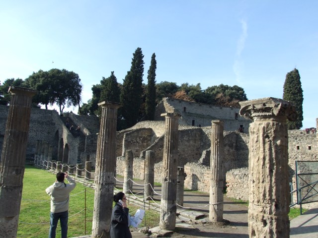 VIII.7.16 Pompeii.  December 2007. North east corner outside the doorkeeper’s room.  Looking across the north side to staircase to the Triangular Forum and the walls of the upper storey of the Large Theatre.
