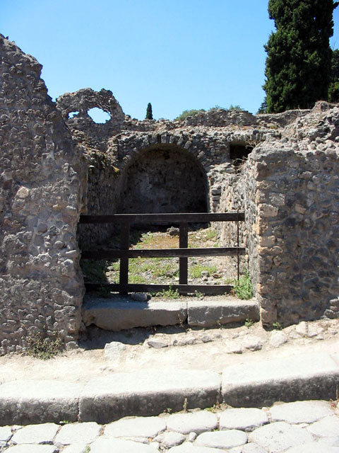 VIII.7.22 Pompeii. June 2009. Exterior wall façade on south side of entrance doorway. 
Photo courtesy of Sera Baker.
