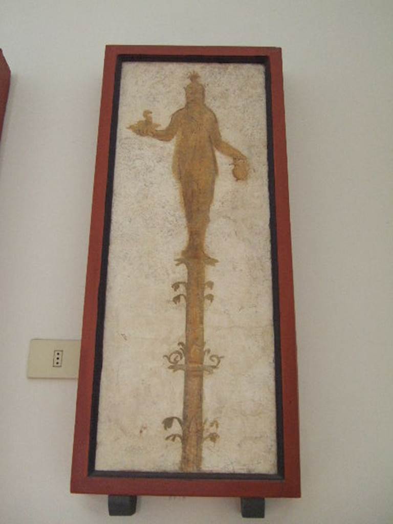 VIII.7.28 Pompeii.  Priestess on a candelabrum with a cobra and jar.  
Found in passageway of arch.  Now in Naples Archaeological Museum.

