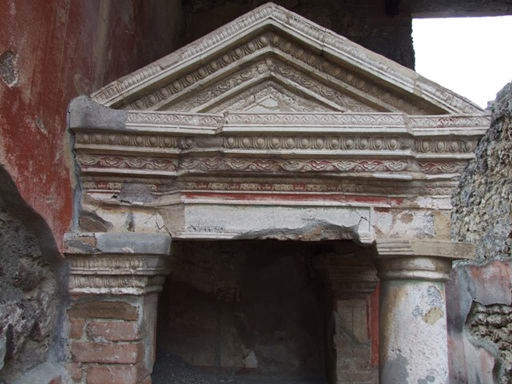 IX.1.22 Pompeii. December 2007. Room 1, atrium. Looking south at ornate top pediment of household shrine in south-east corner. 
