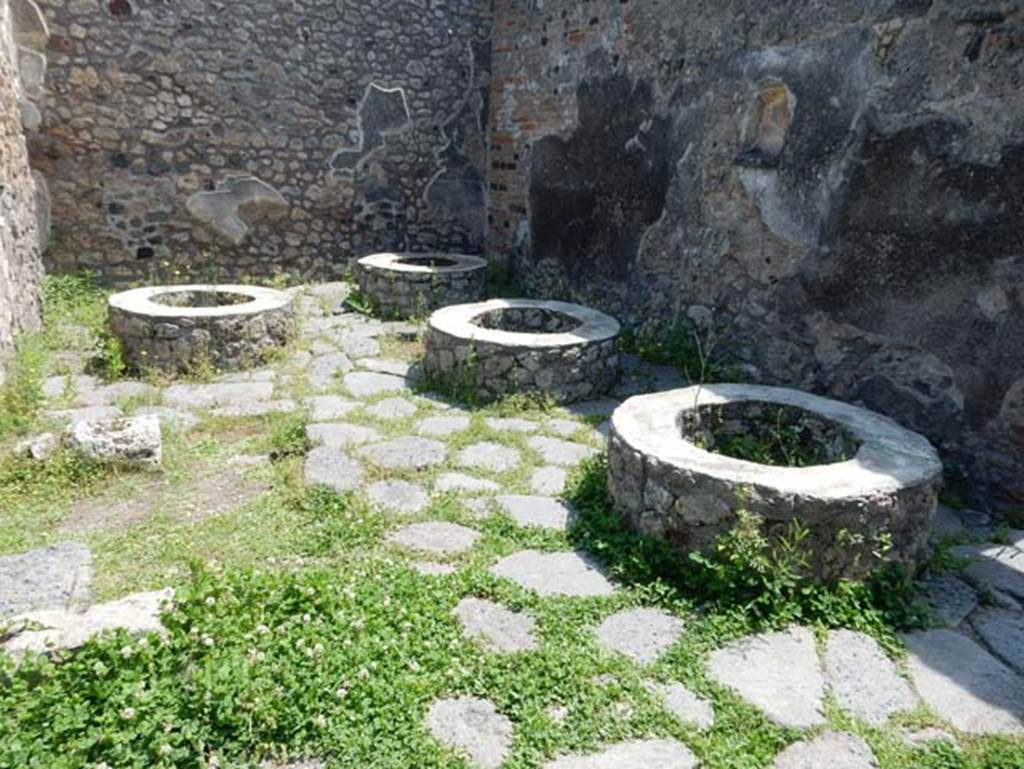 IX.3.12 Pompeii. May 2018. Mills in room on south side of oven. Photo courtesy of Buzz Ferebee.