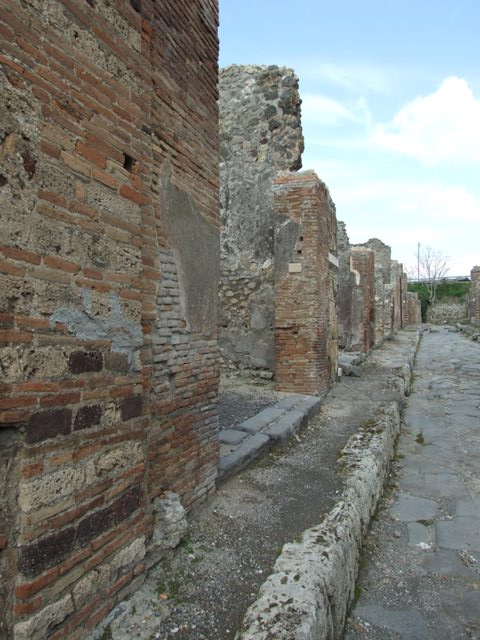 Front wall between IX.3.13 and IX.3.14. December 2007. According to Della Corte, the name of the owner of the caupona was painted in an electoral recommendation to the right of the entrance:
A(ulum)  Vettium  Felicem
aed(ilem)  o(ro)  v(os)  f(aciatis)  Fabius  celer  rog(at)    [CIL IV 3659]
See Della Corte, M., 1965.  Case ed Abitanti di Pompei. Napoli: Fausto Fiorentino. (p.190)

