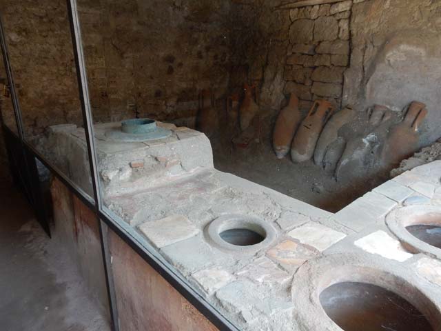 IX.11.2 Pompeii. May 2010. Bar counter, with stove and dolium.
