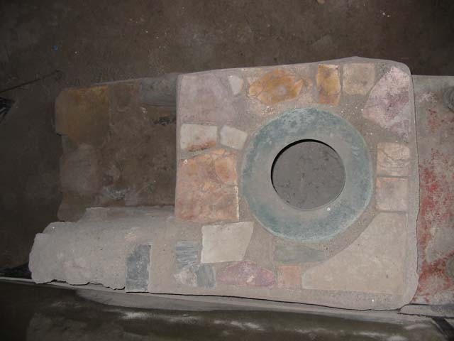 IX.11.2 Pompeii. May 2003. Looking south into hearth under small stove. Photo courtesy of Nicolas Monteix.