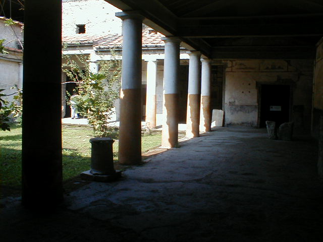IX.13.1-3 Pompeii. May 2010. Room 9, east wall of portico and plaster casts of cupboards.