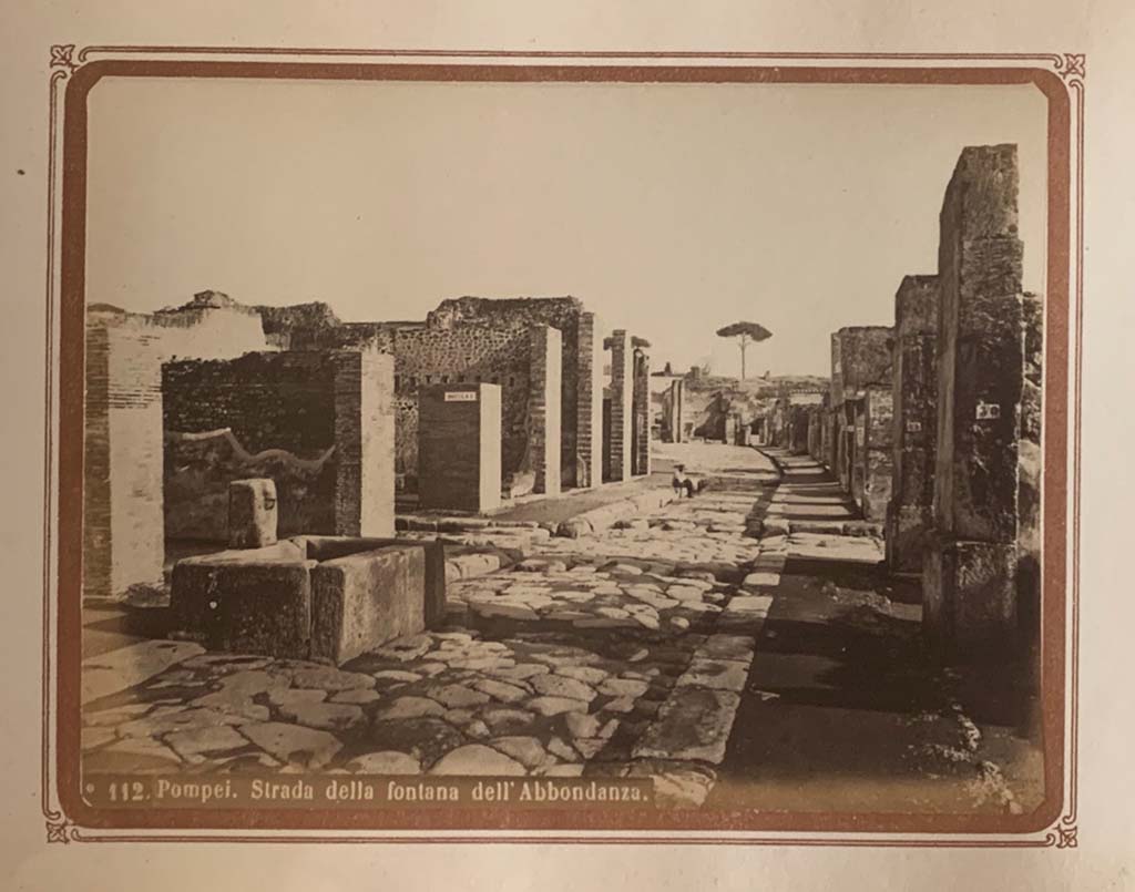 Via dell’Abbondanza, Pompeii. From an album by Roberto Rive, dated 1868. 
Looking east from near fountain at VII.14.13/14. Photo courtesy of Rick Bauer.
